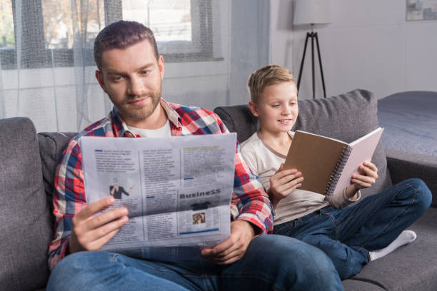 istock father and son reading at home 903206014