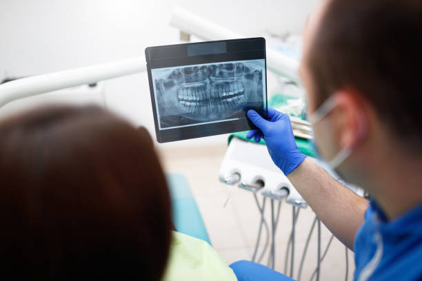 istock Dentist showing a patient her x-ray 903207258