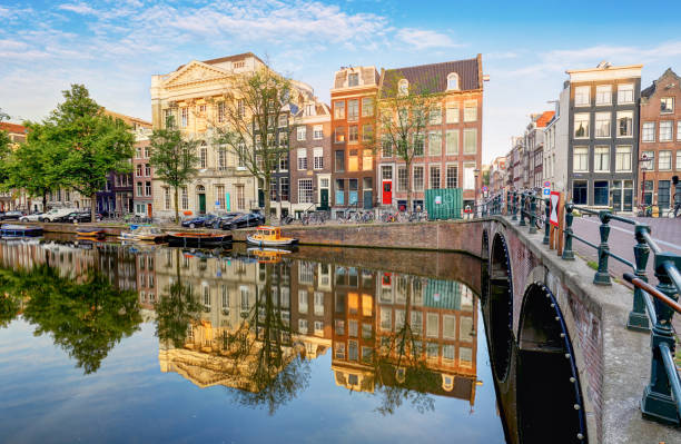 istock Amsterdam Canal houses  vibrant reflections, Netherlands, panorama 903209946