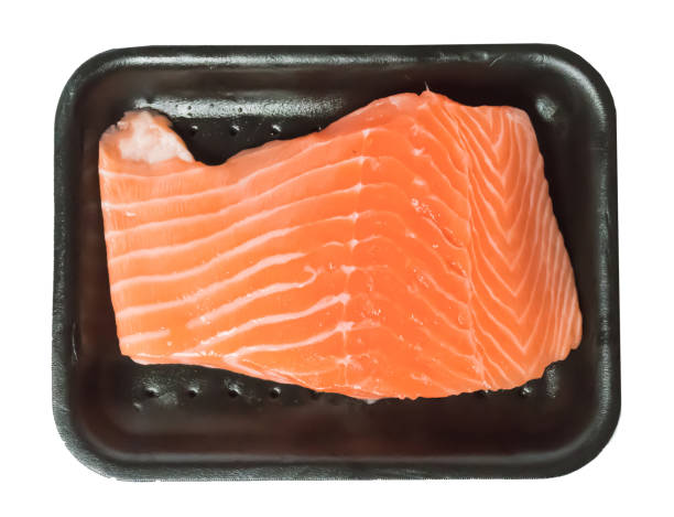 Fresh salmon filet in black tray and white background stock photo
