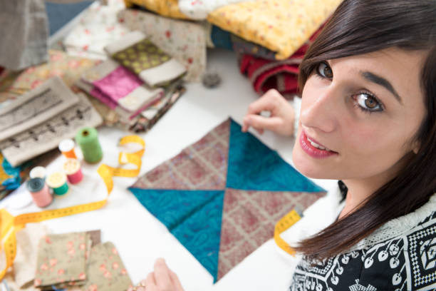 istock a portrait of a young seamstress in her studio 903217802