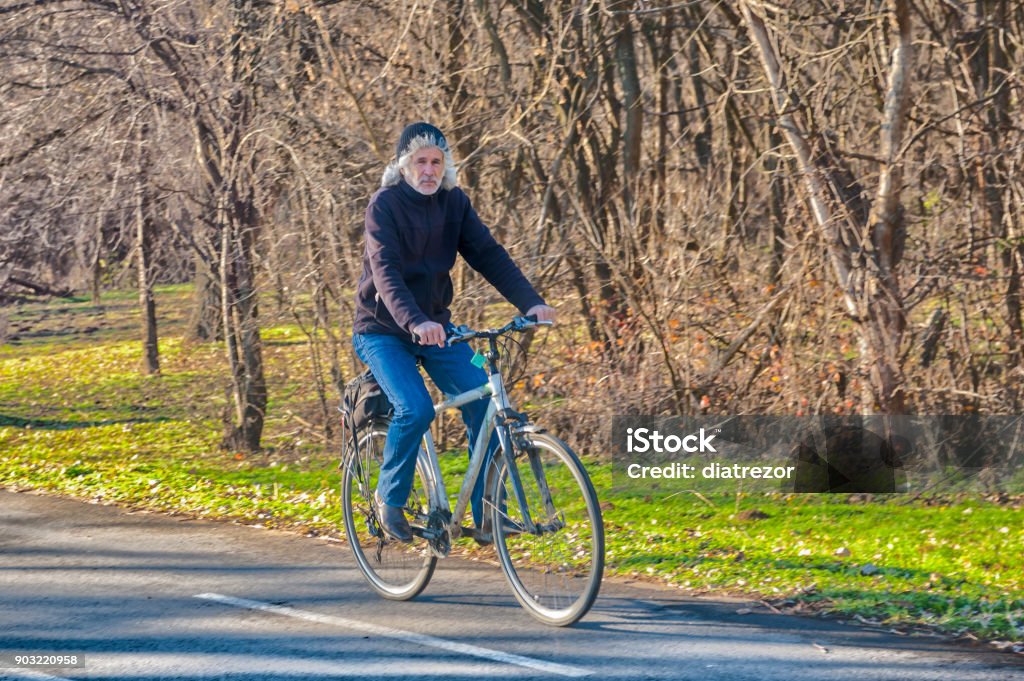 Active senior man outdoors riding his bike. Nature. 70-79 Years Stock Photo