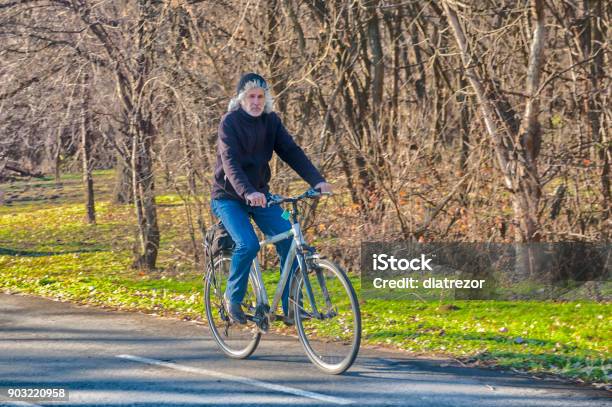 Active Senior Man Outdoors Riding His Bike Nature Stock Photo - Download Image Now
