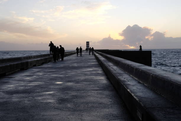 istock blurry people walking on the pier in winter 903224330