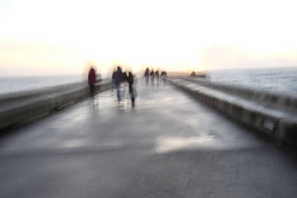istock blurry people walking on the pier in winter 903224684