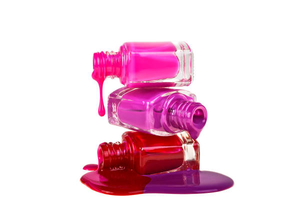 istock Nail polish dripping from stacked bottles isolated on white background 903224768
