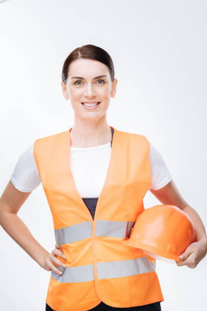 istock Brunette female worker  holding hard ha 903224956