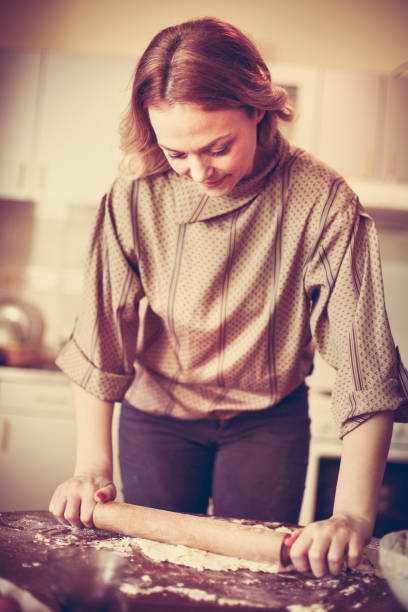 istock Blonde woman baking cookies. Close up. 903226236