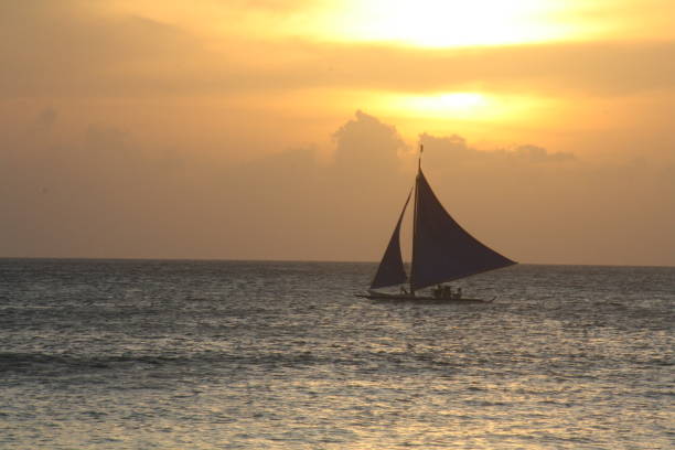 istock Boat at sunset off white beach, Boracay, Philippines 903229584