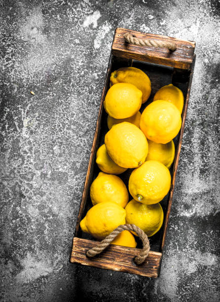 istock Fresh lemons in a wooden box. 903229678