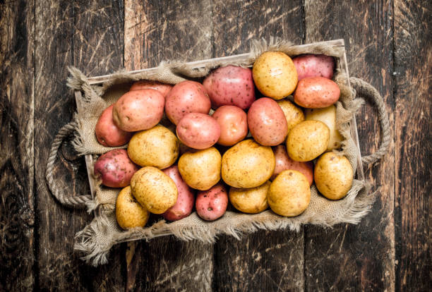 istock Fresh potatoes on a wooden tray. 903229750