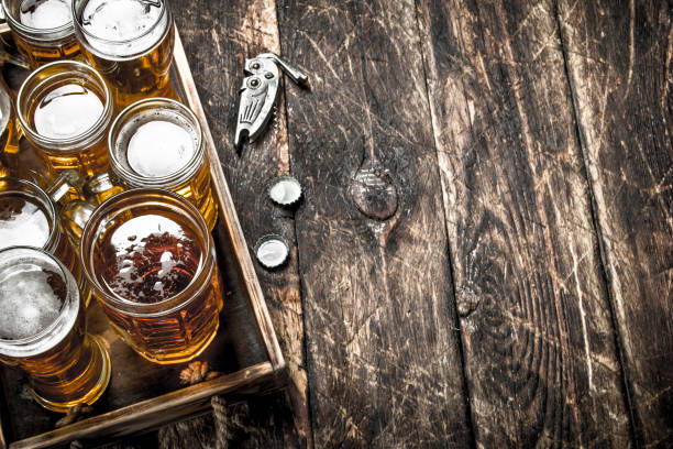 istock Glasses with fresh beer on an old tray. 903233424