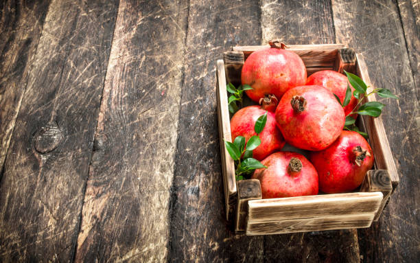 istock Fresh pomegranates in an old box. 903237918