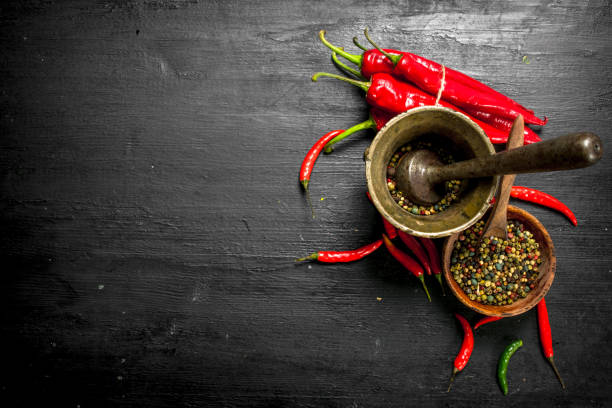 istock Grain of hot pepper in a mortar with a pestle. 903238162