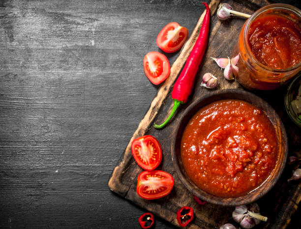 istock Tomato sauce with garlic and hot peppers on the Board. 903238168