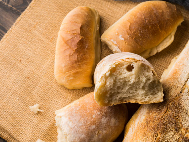 istock Freshly baked bread on burlap dark wooden background 903242614