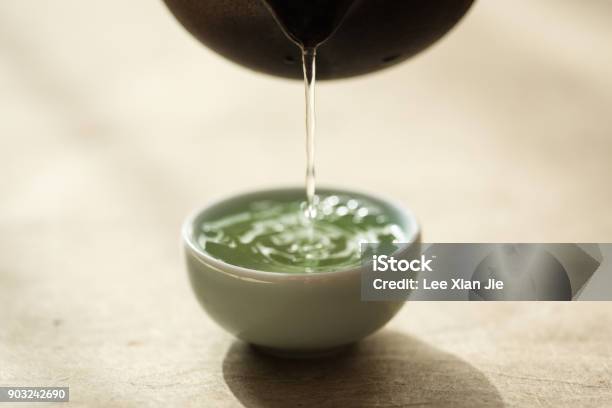 Sencha Being Poured Into A Celadon Teacup Stock Photo - Download Image Now - Green Tea, Pouring, Sencha Tea