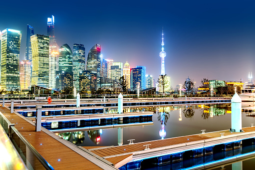 Cityscape of Shanghai Downtown at night reflected in the river, China