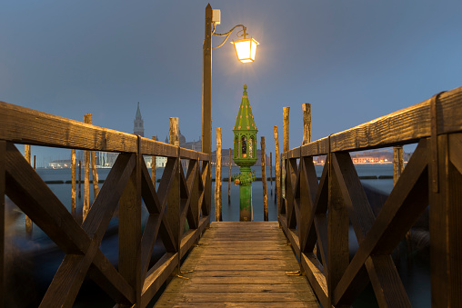 wooden pier with handrails in Venice by night