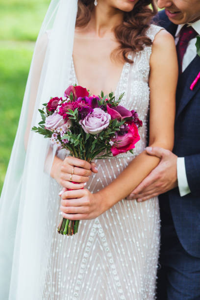 istock Wedding couple holding hands. wedding bouquet 903250084