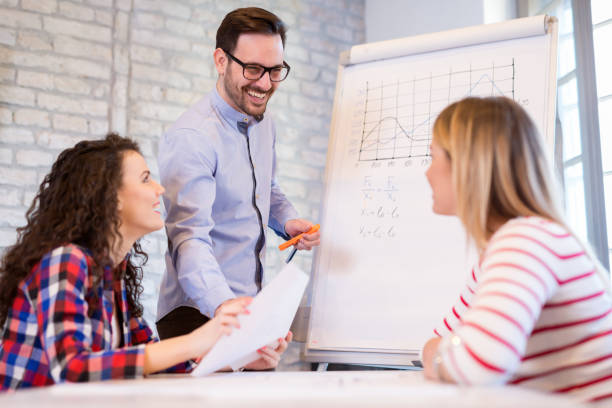 istock Coworkers working on project together in office 903250364