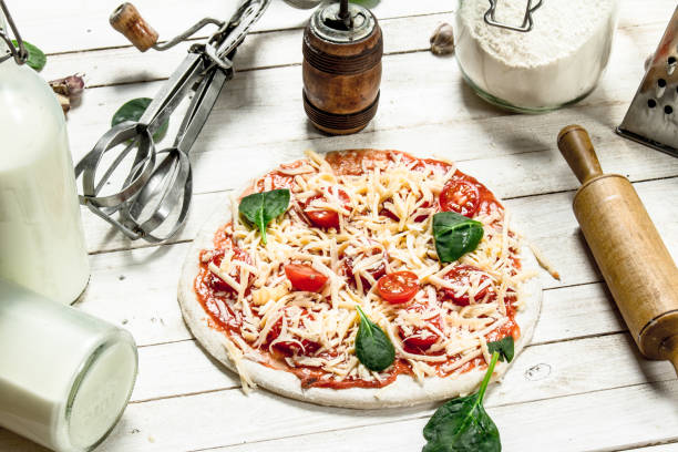istock Preparation of pizza with various ingredients. 903250532