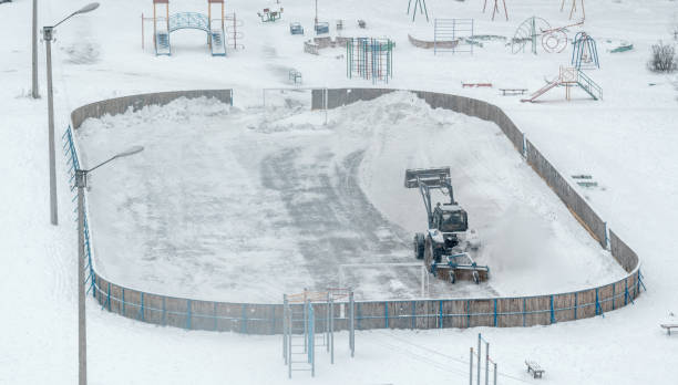 istock Tractor Removes Snow on Ice Rink at Playground 903251898