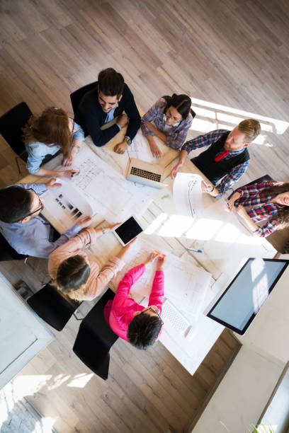 istock Group of coworkers working on project together in office 903253536