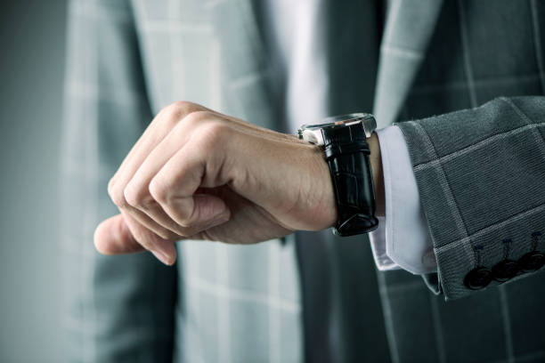 istock businessman watching his wristwatch 903257580