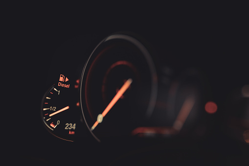 Close up shot of the electronic fuel gauge of a car.
