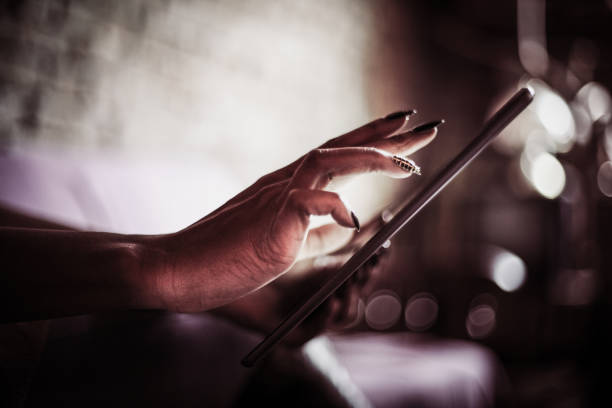 istock Woman working on iPod. Focus on hand. Close up. 903265354