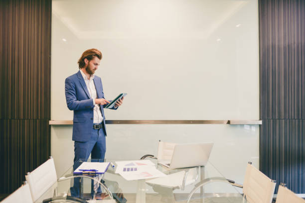istock Stressed western businessman using a tablet isolated with blank board 903265506