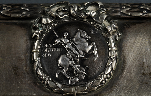 Close up view of engraved silver sign St. George slaying the dragon
