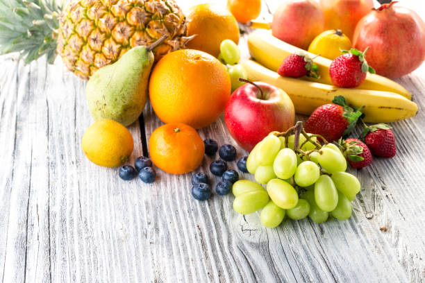 istock Fresh fruits on wooden background 903270506