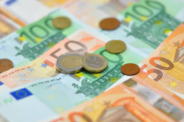 istock Euro coins over paper euro banknotes. 903270952