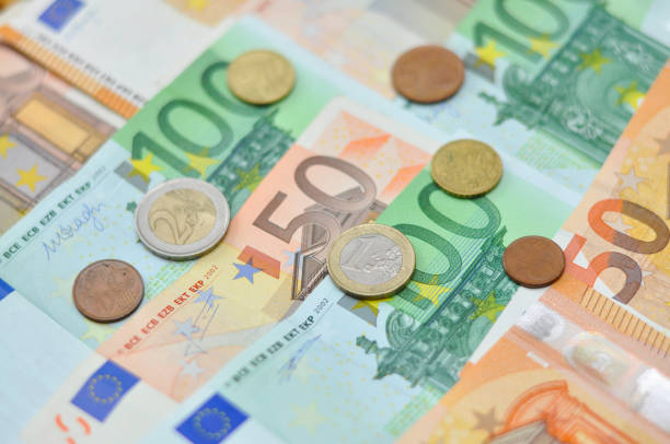istock Euro coins over paper euro banknotes. 903270954