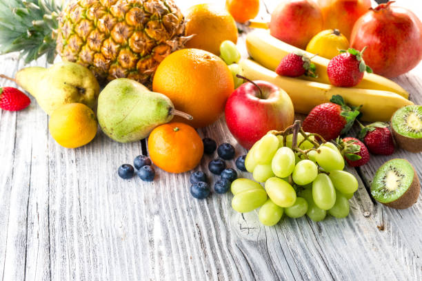 istock Fresh fruits on wooden background 903277384