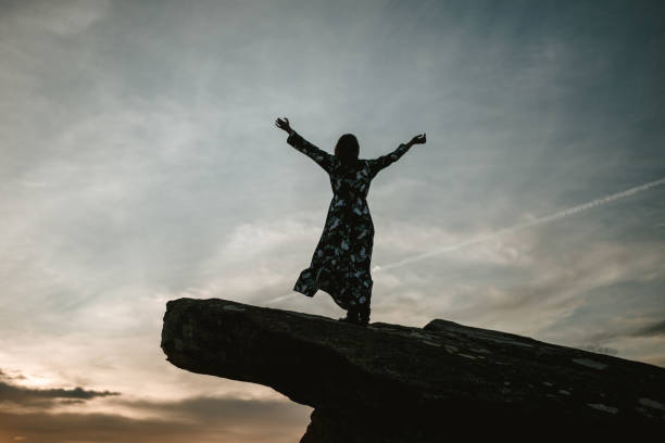 istock Young woman with arms raised 903280502