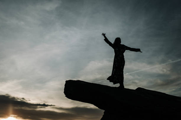 istock Young woman with arms raised 903280532