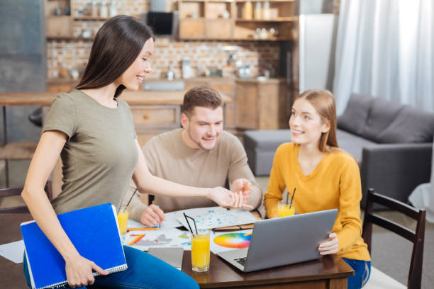 istock Beautiful lady pointing at the laptop while sitting on the table 903281578