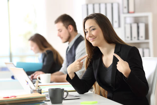 Proud businesswoman pointing himself at office