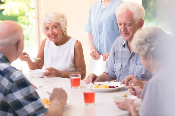 istock Smiling senior woman eating soup 903283132