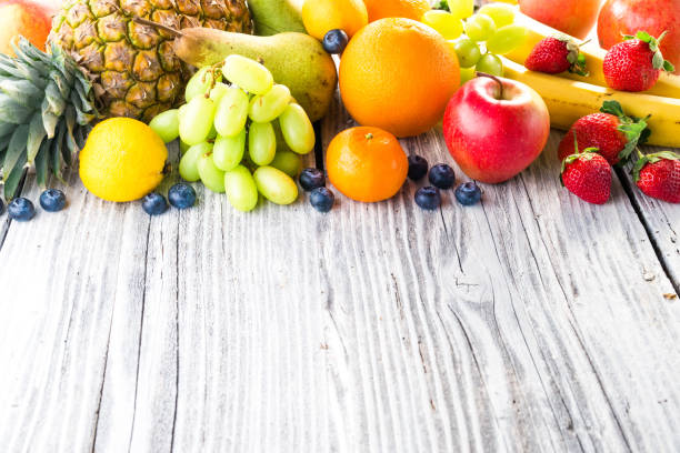 istock Fresh fruits on wooden background 903283296