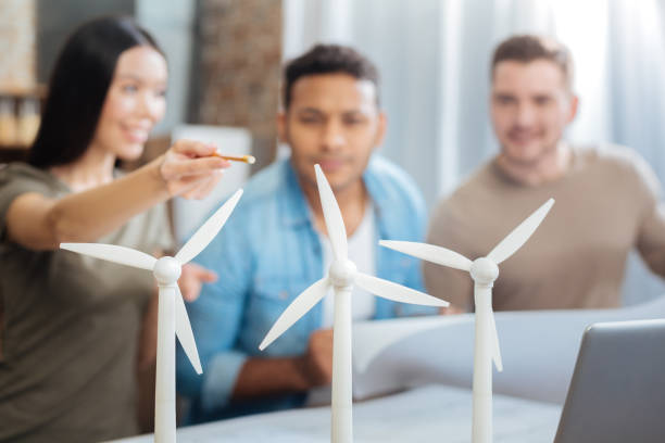 istock Three young engineers discussing wonderful windmill turbines 903283314