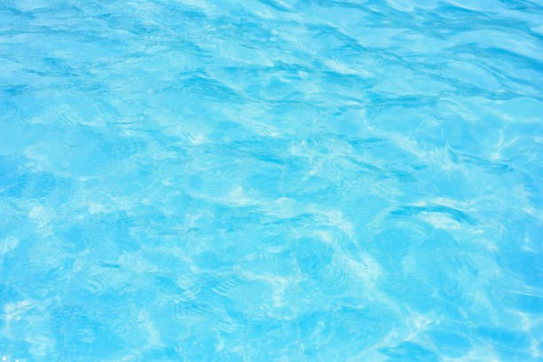istock Ripple water in swimming pool with sun reflection 903290356