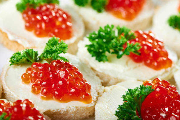 tasty canapees with butter and red caviar - plank bread caviar close up imagens e fotografias de stock