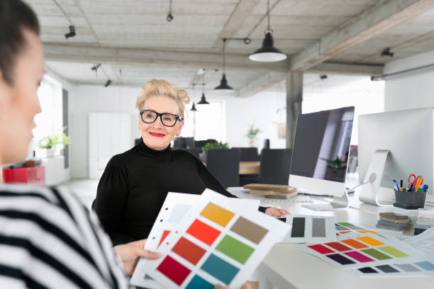 istock Senior and young interior designers working together in the office 903290844