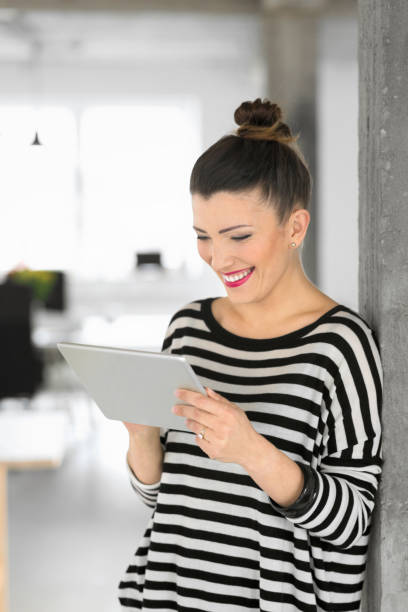 istock Creative young woman using a digital tablet in the office 903291074