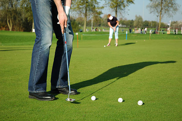 istock Man and woman putting shadows on green 90329178