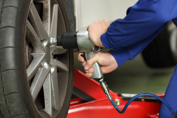 istock Car mechanic loosen wheel nuts in a workshop 903294054